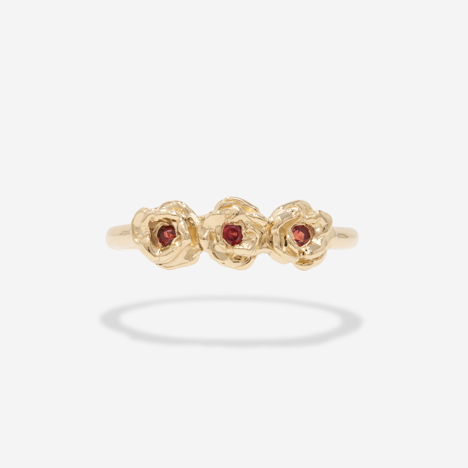 Three rose ring with red sapphire centers.