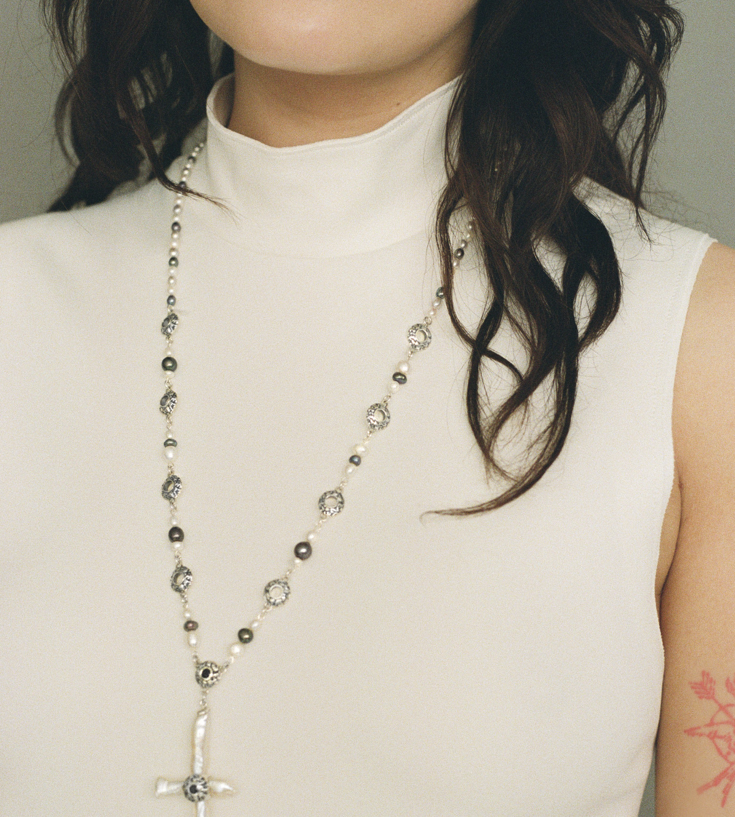 Freshwater cross pearl necklace with sterling silver and black sapphire accents.