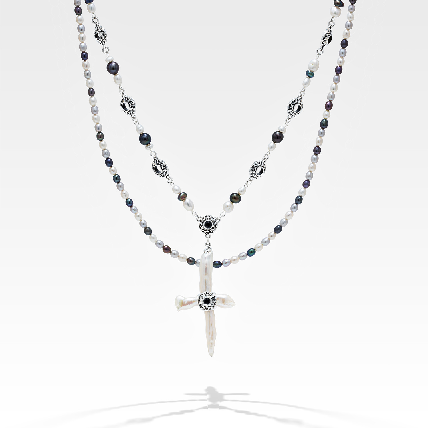 Freshwater cross pearl necklace with sterling silver and black sapphire accents.