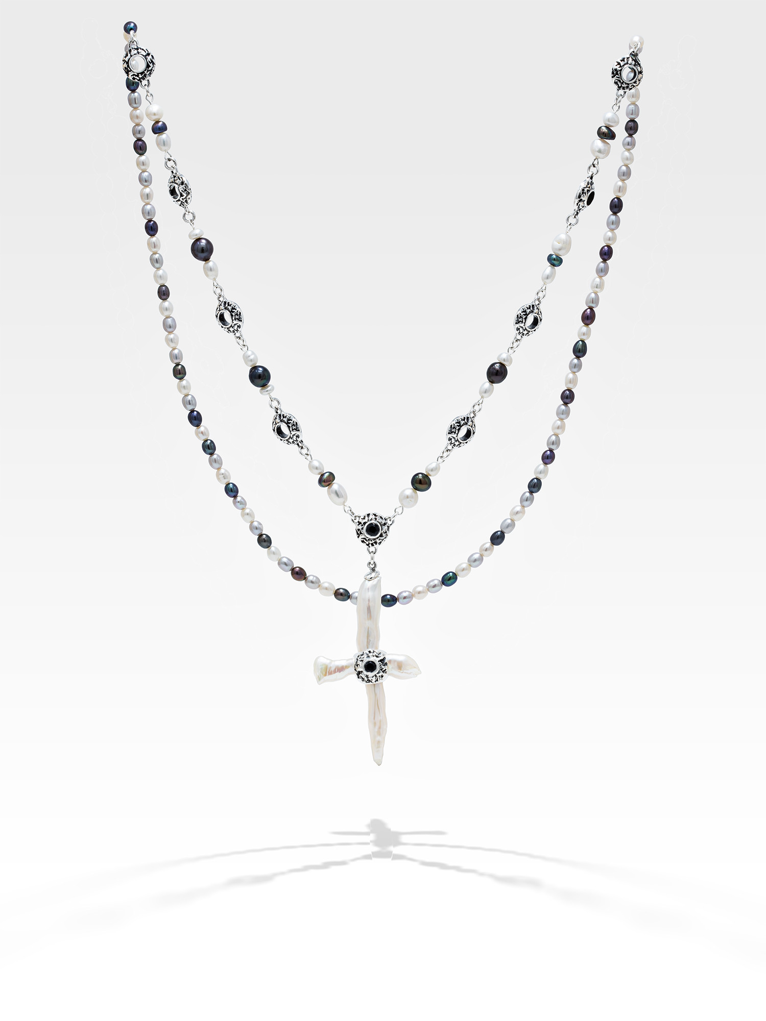 Freshwater cross pearl necklace with sterling silver and black sapphire accents.