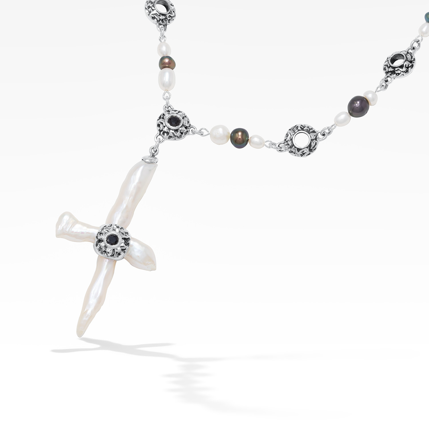 Freshwater cross pearl necklace with sterling silver and black sapphire accents.