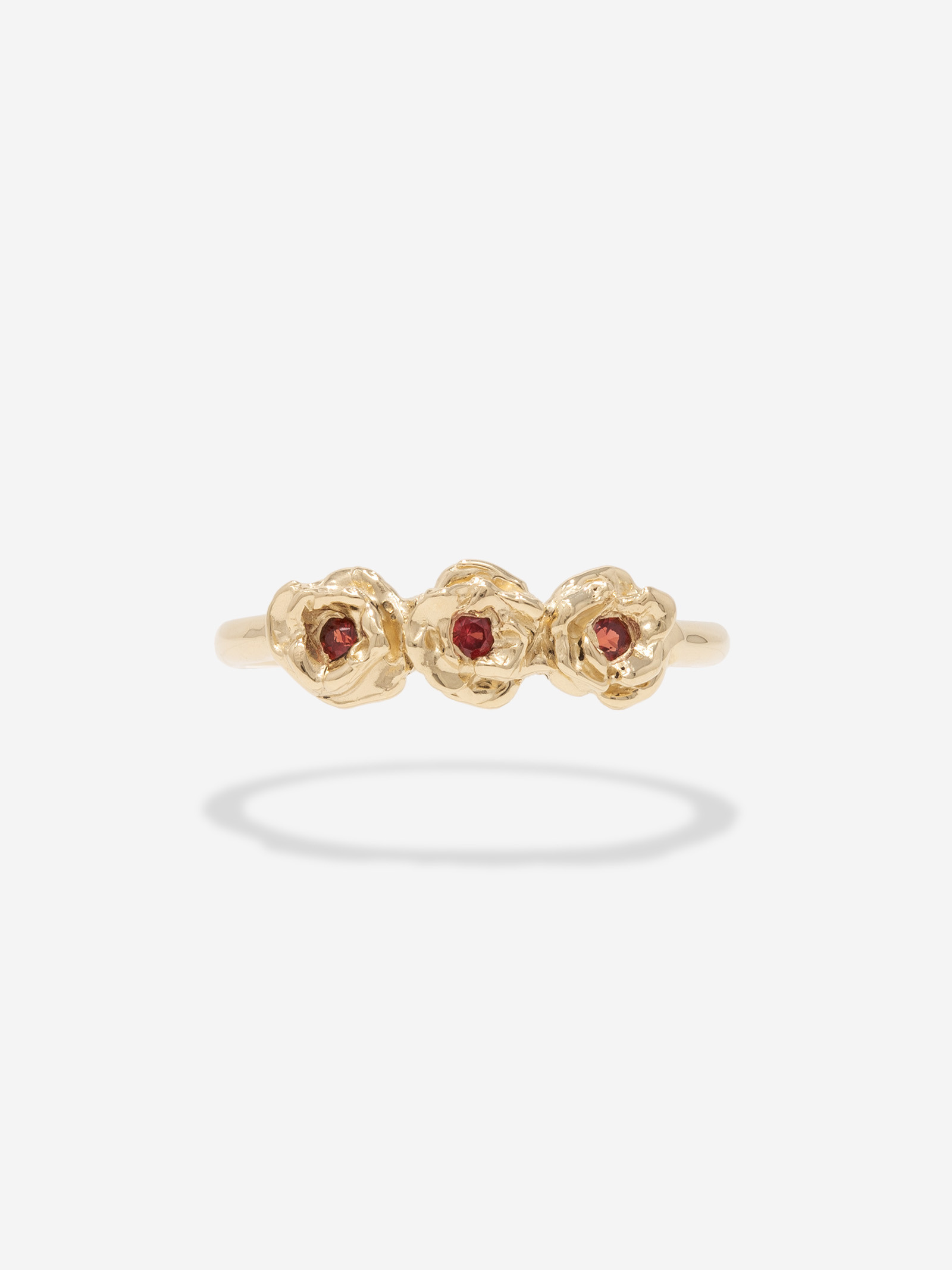 Three rose ring with red sapphire centers.