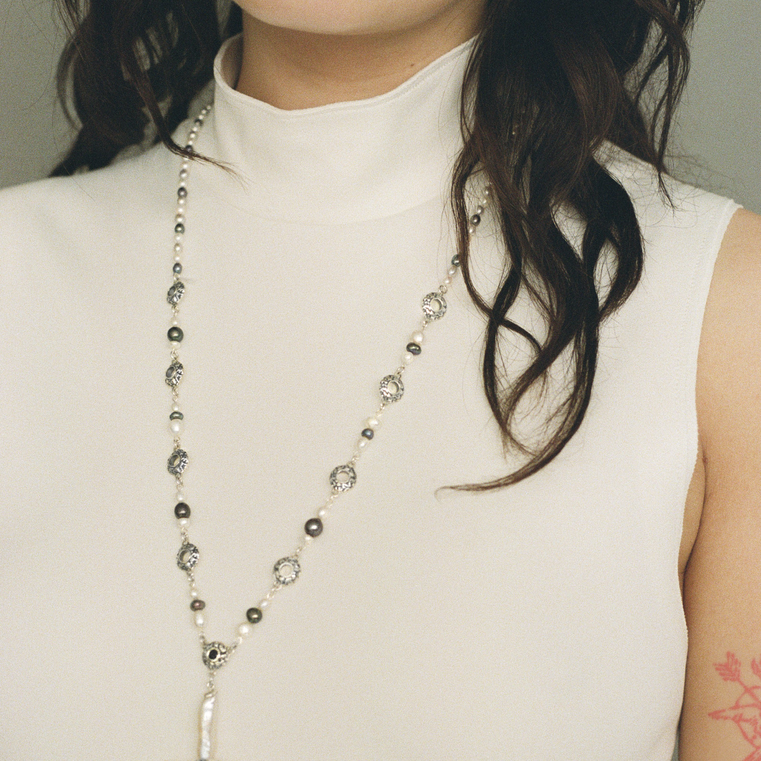 Freshwater cross pearl necklace with sterling silver and black sapphire accents.